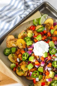 Loaded plantain nachos on a baking sheet.