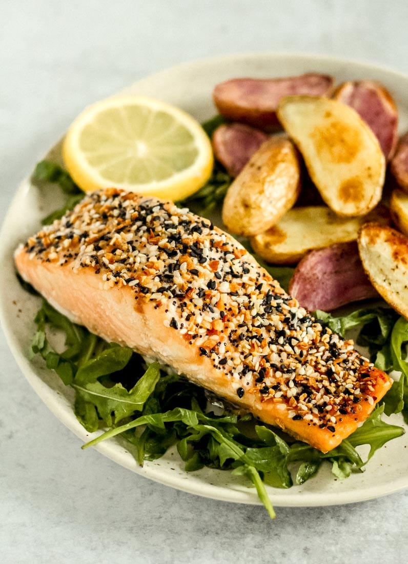 Everything bagel salmon on a bed of arugula with a side of fingerling potatoes.