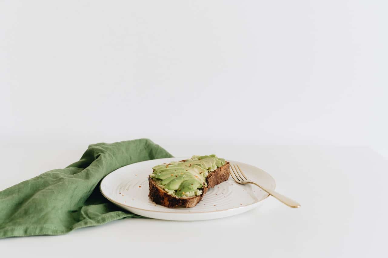 Are avocados bad for you? Avocado toast on white plate.